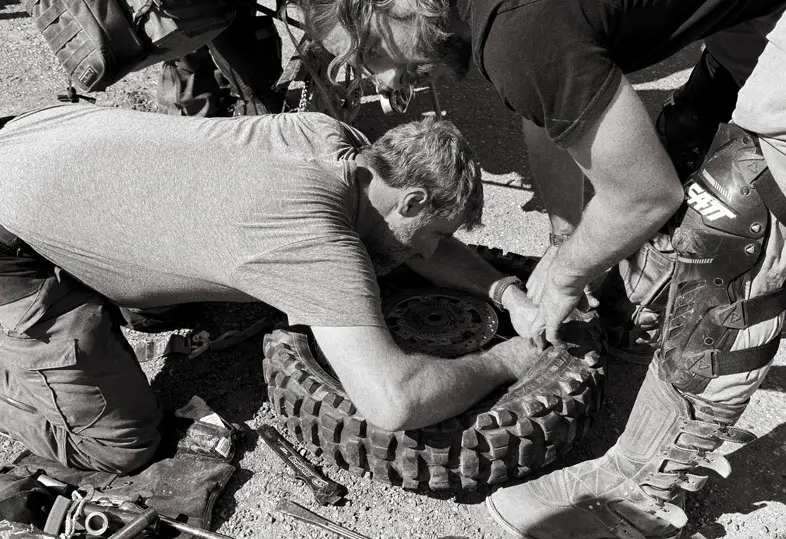 Riders preparing dirt bikes for a moto training session
